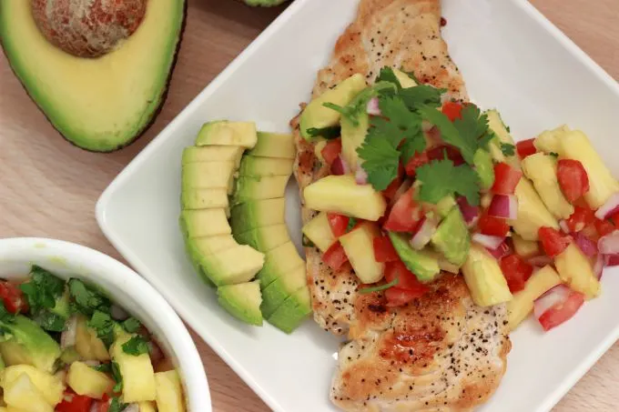 Grilled Chicken with Tropical Salsa-A delicious grilled chicken recipe topped with avocado and other flavorful ingredients to create a tasty and simple dish. 