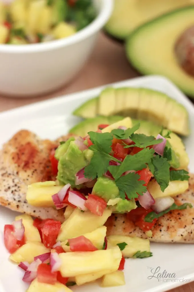 Grilled Chicken with Tropical Salsa-A delicious grilled chicken recipe topped with avocado and other flavorful ingredients to create a tasty and simple dish. 